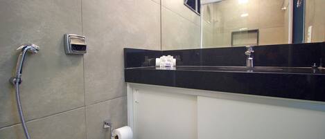 A bathroom with a shower, toilet, and a mirror.