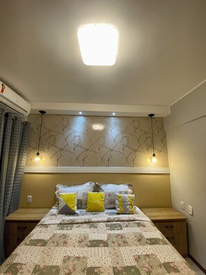 Ein Schlafzimmer mit einem Bett, Nachttischen, einer Wandleuchte und einer Deckenlampe.
