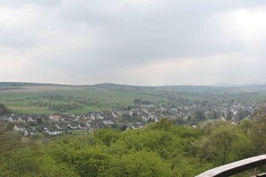 A rural landscape with a village, rolling hills, and a cloudy sky. - Holiday apartment Rhine-Ahr (Sinzig)