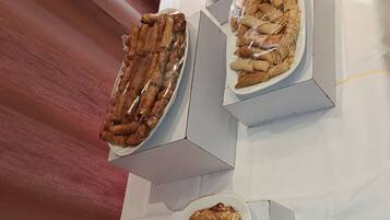 A table with three rectangular food containers, each containing different food items.