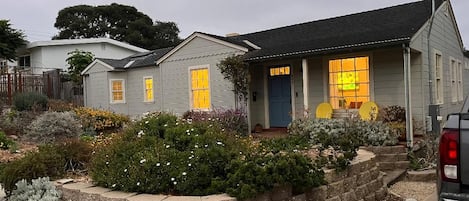 A residential house with a front porch, a garage, and a driveway.