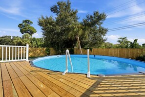 A swimming pool with a wooden deck and a white fence. - Venice Island Florida pool Home (Venice)