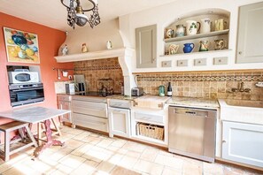 A kitchen with white cabinets, a microwave, a toaster, and a dishwasher. - Holiday home in Sarrians with swimming pool (Sarrians)