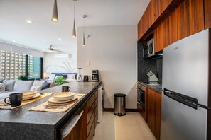 A modern kitchen with a built-in refrigerator, microwave, and coffee maker. - Infinity Pool & Hot Tub | Romantic Zone Hideaway (Puerto Vallarta)
