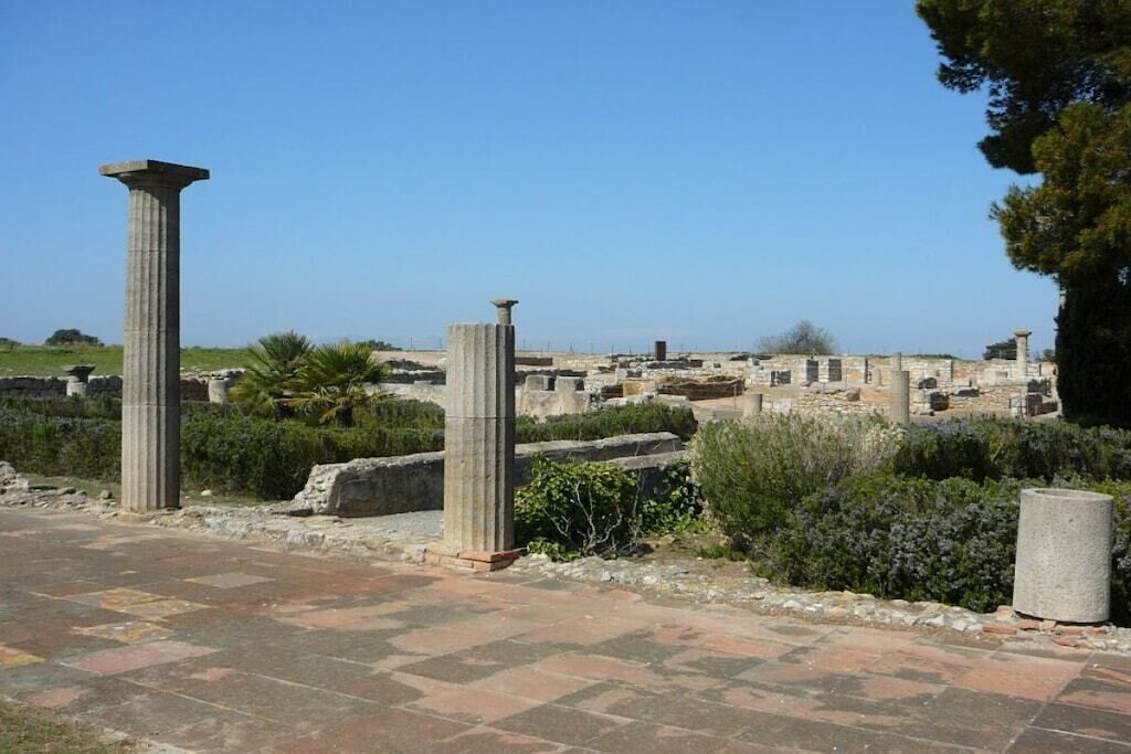 Ancient ruins with columns and stone structures.