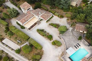 A large property with multiple buildings, a swimming pool, and well-maintained gardens.