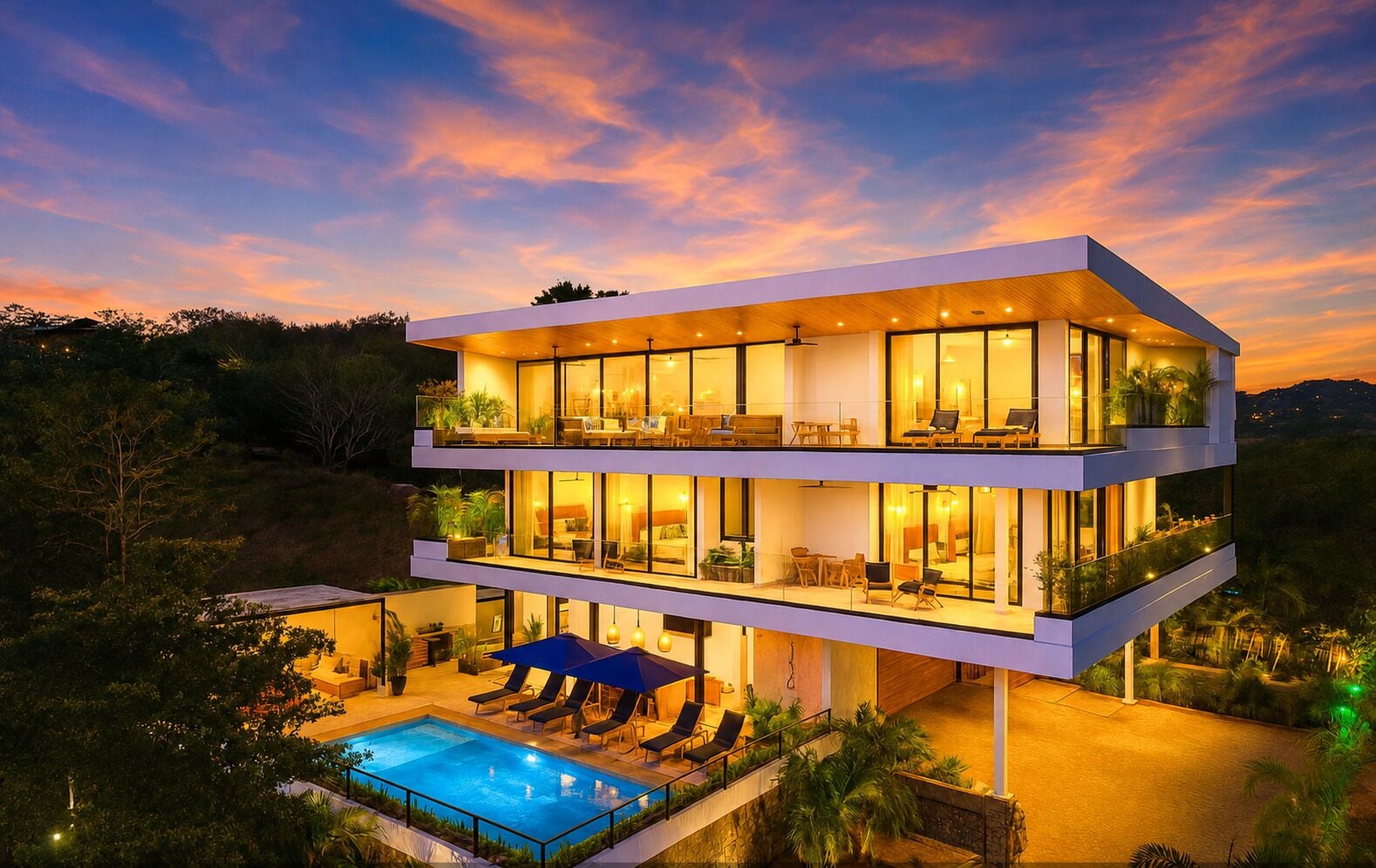 A modern multi-story building with a pool and outdoor seating.