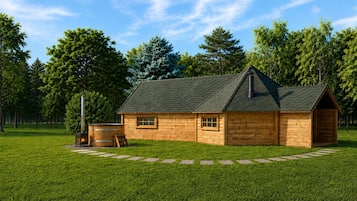 A wooden cabin with a stone pathway leading to it, surrounded by lush greenery and trees.