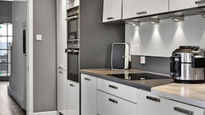 A modern kitchen with built-in appliances, grey cabinets, and a stainless steel coffee maker. - Stunning  villa for 8 people with WIFI and terrace (Ardrossan)