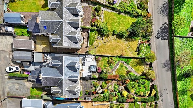 An aerial view of a residential area with multiple houses, a road, and a green park area. - Stunning  villa for 8 people with WIFI and terrace (Ardrossan)