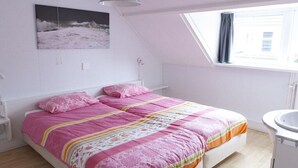 A bedroom with a bed, a window, a bedside table, and a wall-mounted picture. - Holiday home in Domburg with swimming pool (domburg)