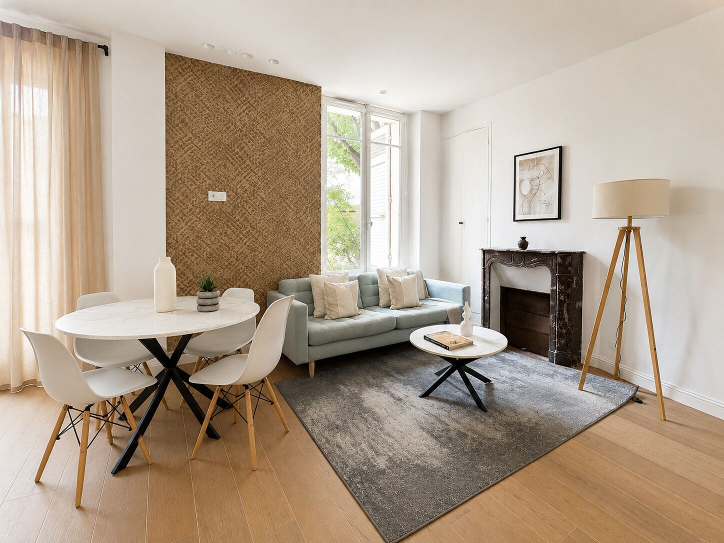Ein modernes Wohnzimmer mit einem runden Esstisch, einer Couch, einem Kamin und einer Stehlampe.