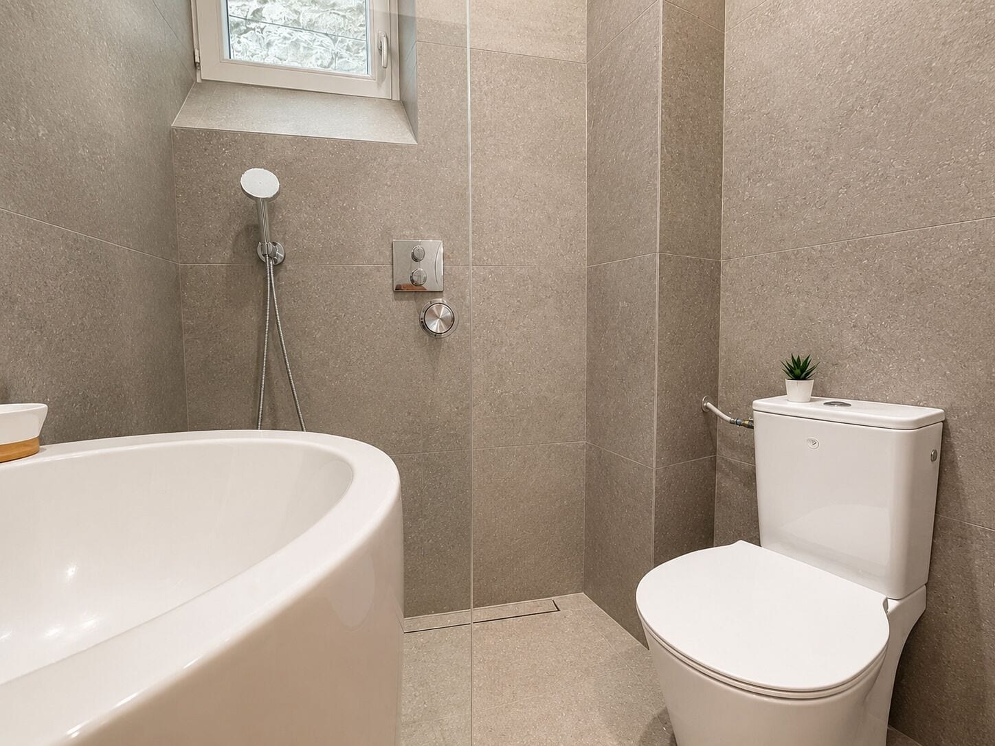 Ein Badezimmer mit Badewanne, Toilette und Dusche.