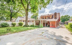 A residential property with a covered patio, a brick exterior, and a fenced yard. - Near Shopping & Dining- Magic in Midtown- 2 Units (Memphis)