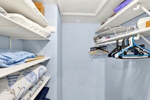 A closet with shelves, hanging space, and a shoe rack. - 2bd Condo close to pool and restaurants  (Siesta Key)