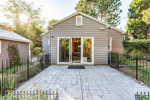 A house with a covered patio, a sliding glass door entrance, and a fenced yard. - Red Butte River Gem-Close to the U, Downtown & Mtn (Salt Lake City)