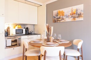 A modern kitchen with white cabinetry, a microwave, and a toaster. - Central London 1BR | Trafalgar Square | Sleeps 4 (London)