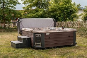 A hot tub with a cover, steps, and a label. - Cabin in Inzell with swimming pool (Inzell)