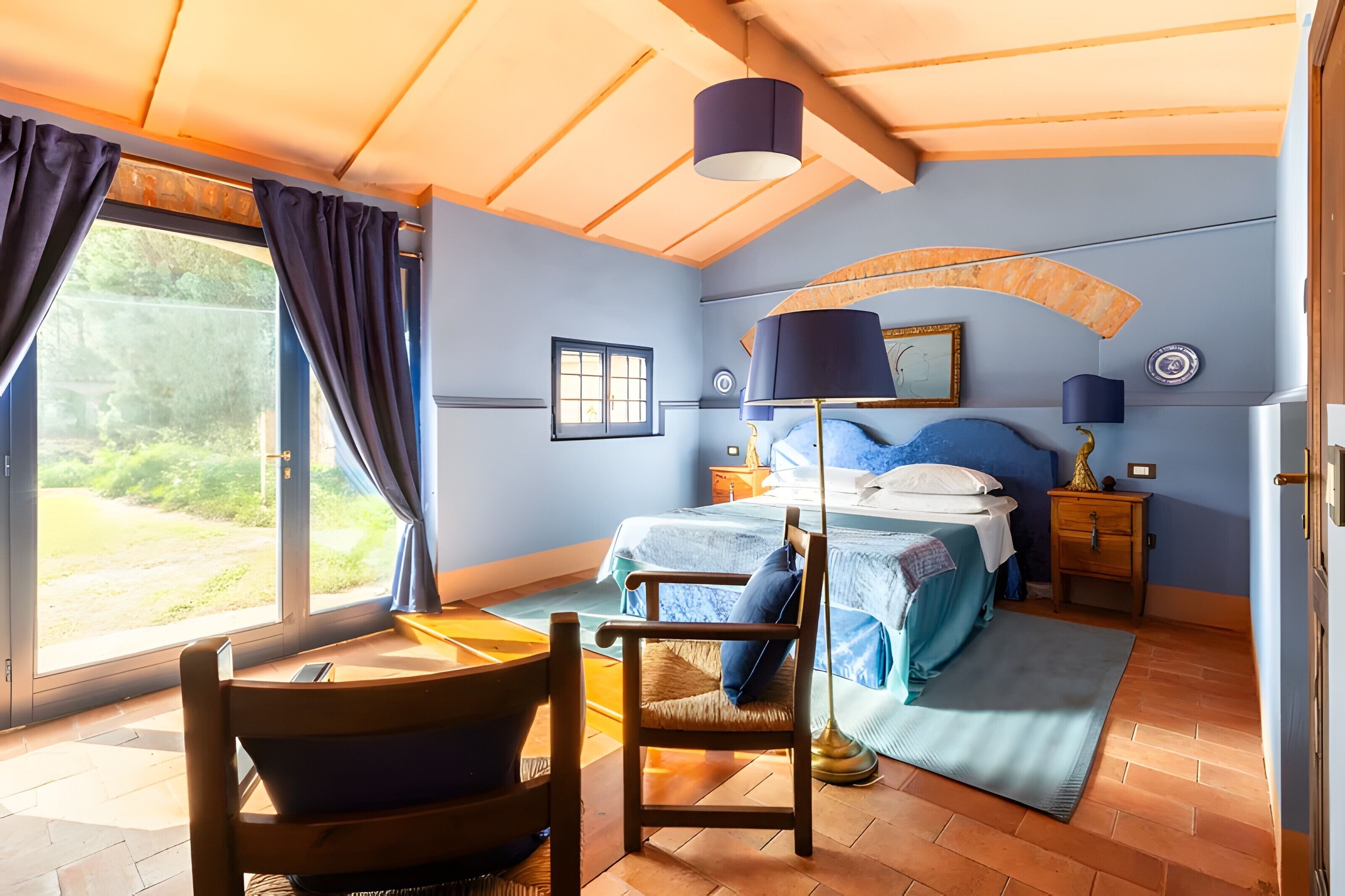 Une chambre à coucher avec un lit, une chaise, un bureau et une fenêtre.