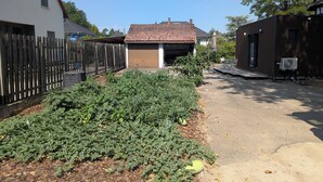 A residential area with a house, a fenced yard, and a garage.