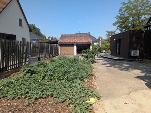 A residential area with a house, a fenced yard, and a garage.