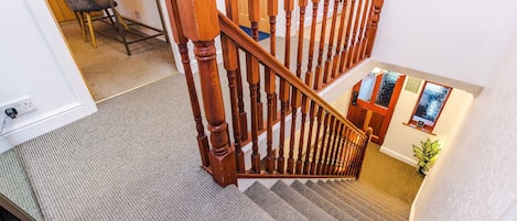A staircase with wooden balusters leading to a landing.