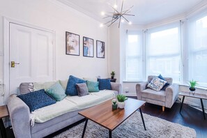 A living room with a sofa, armchairs, a coffee table, and a chandelier. - Bright 3BR Home Manchester Wi-fi Parking (Manchester)