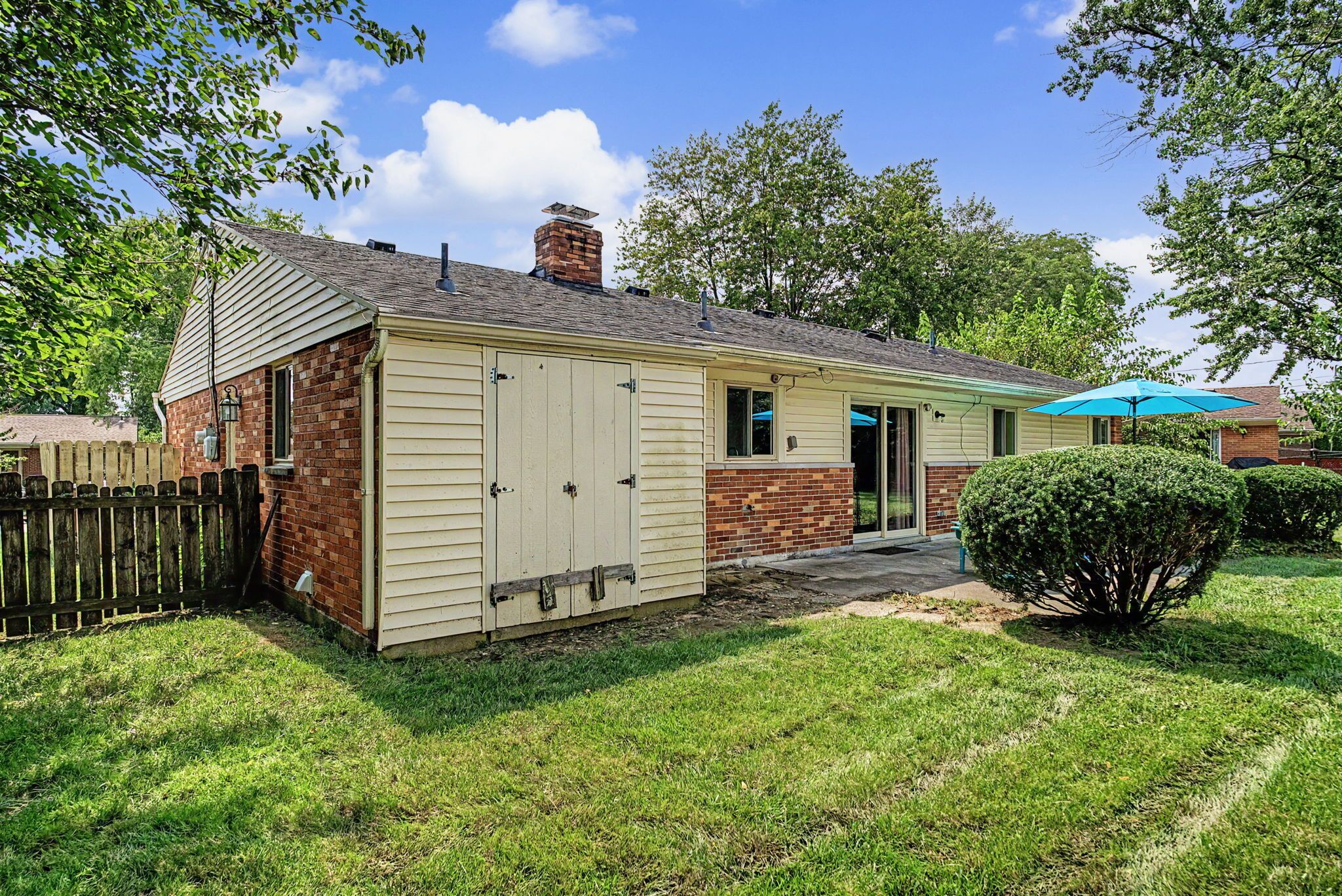 A single-story house with a brick exterior and a small attached garage.