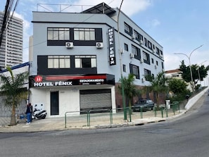 A modern hotel with a two-story structure, a visible entrance, and a parking area.