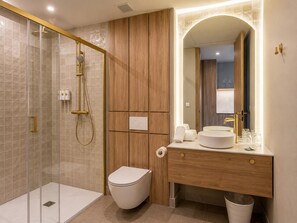 A modern bathroom with a glass-enclosed shower, a wooden vanity with a sink, and a mirror. - Apartment La Plaza 2 Deluxe With Jacuzzi (Alicante)
