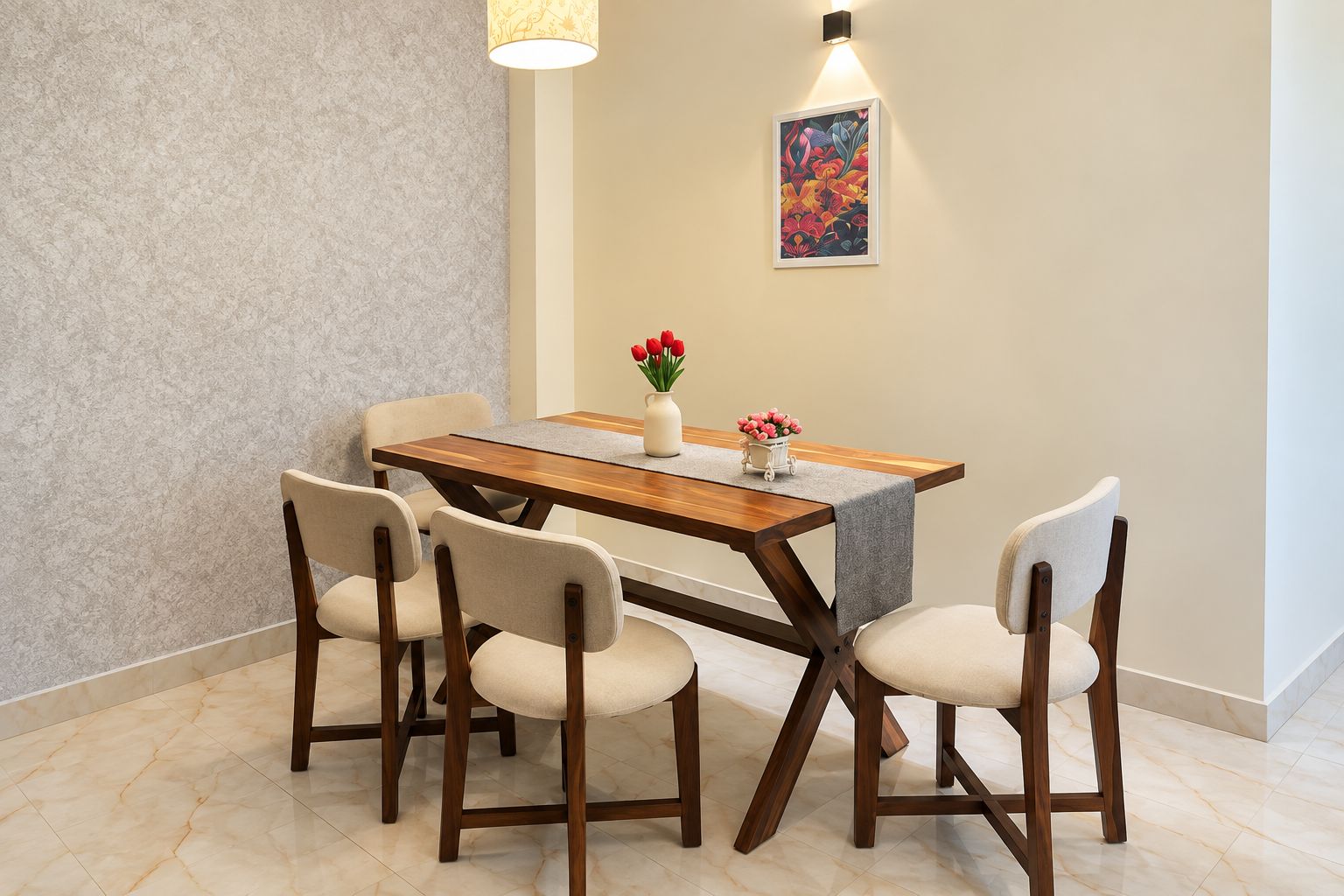 A dining area with a wooden table, four chairs, a vase with flowers, and a wall-mounted light fixture.