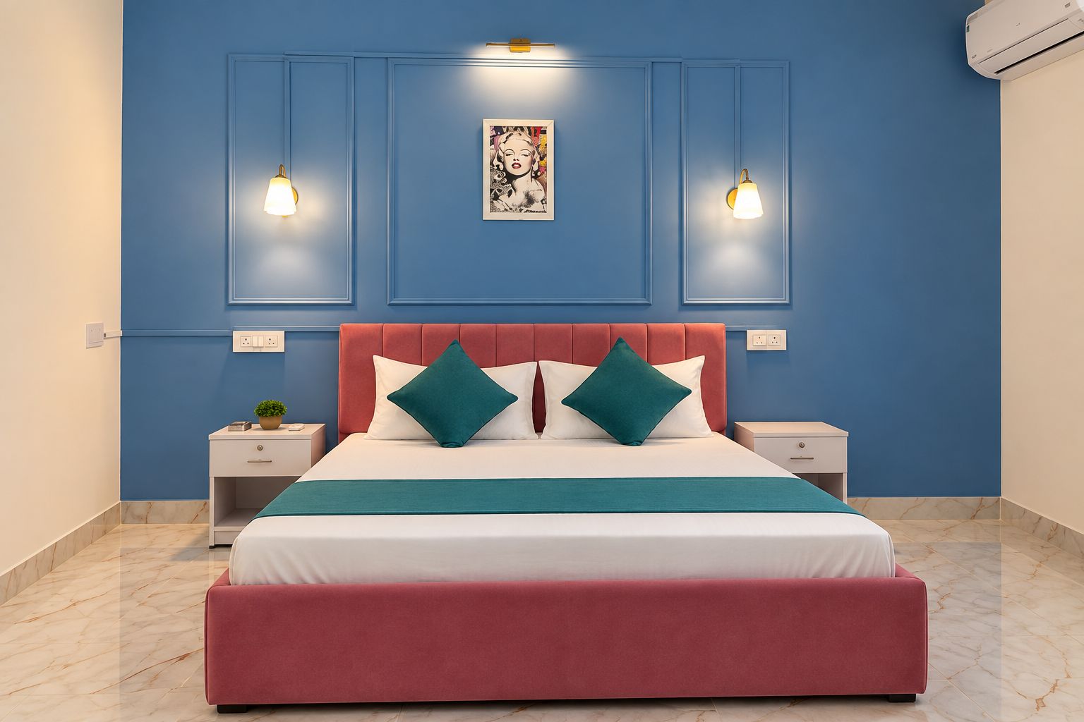 A bedroom with a bed, two bedside tables, a nightstand, a wall-mounted air conditioner, and a framed picture above the bed.