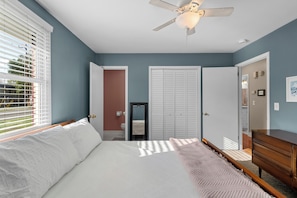 A bedroom with a bed, a ceiling fan, a dresser, and a door leading to another room. - Modern home - 15 mins to DT Nashville & BNA (Antioch)