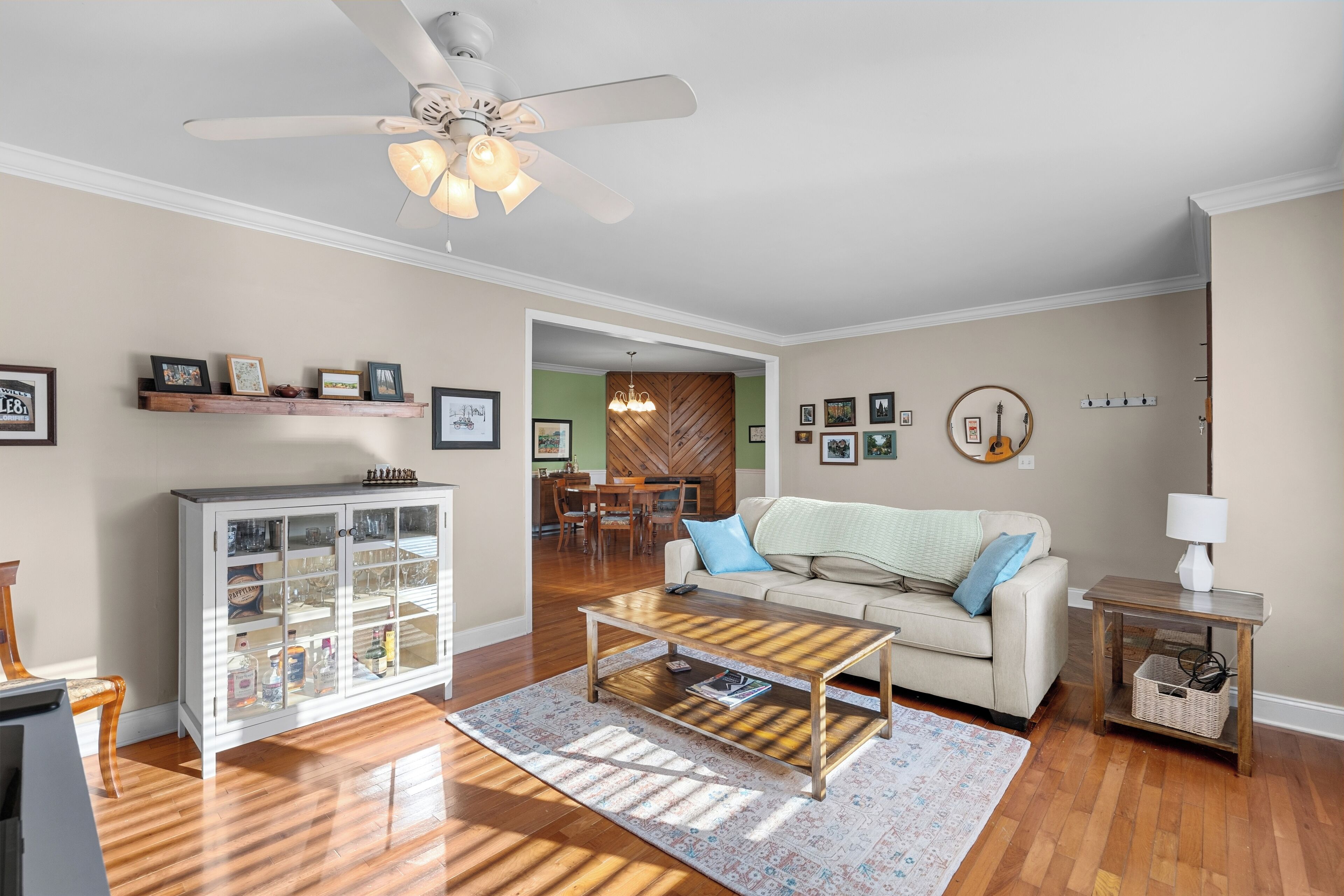 A living room with a sofa, coffee table, and a cabinet with glass doors.
