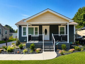 A two-story house with a front porch, a mailbox, and a driveway. - Encore Retreat, home away from home with extra, including ev charging (Elizabethtown)