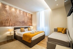 A modern hotel room with a large bed, a sofa, a wall-mounted artwork, and a window with curtains. - Relax Retreat in Historic Florence - Private Sauna & Hydromassage (Firenze)