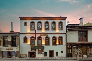 A two-story building with arched windows and a signboard. - Mudurnu Aşiyan Evleri (Mudurnu)