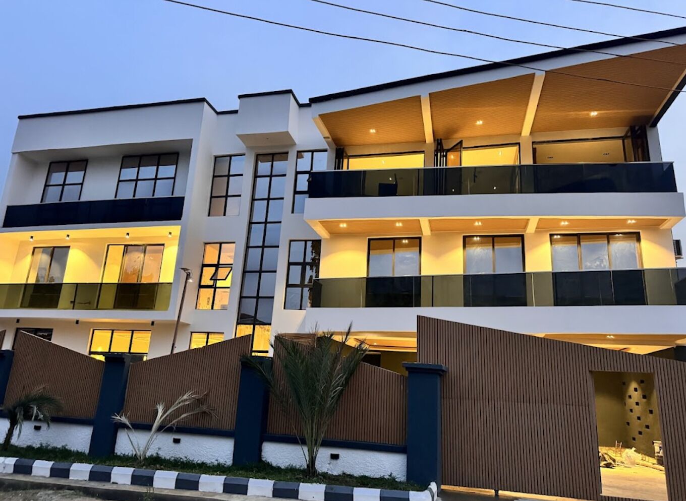 A multi-story residential building with balconies and large windows.