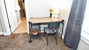 A small workspace with a wooden table, a chair, a lamp, and a potted plant. - Entrada at Moab 624 and 632 (Moab)