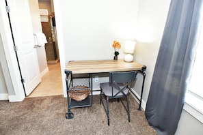 A small workspace with a wooden table, a chair, a lamp, and a potted plant. - Entrada at Moab 624 and 632 (Moab)