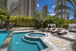 A swimming pool with a hot tub, lounge chairs, and palm trees. - Mountain-city Views Condo at Allure W/parking (Honolulu)