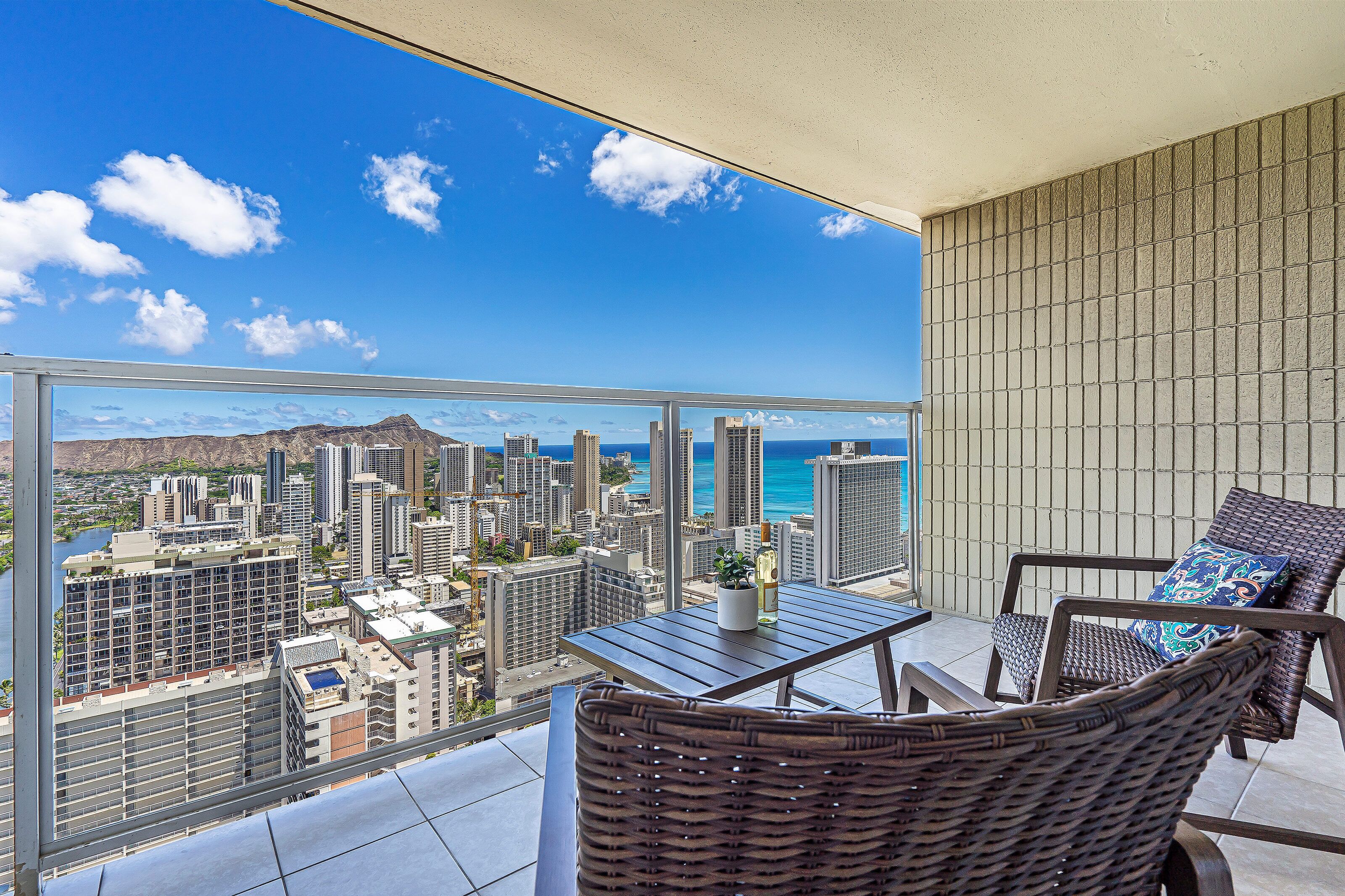 A balcony with a view of a cityscape and ocean.