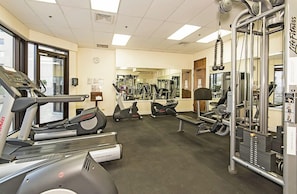 A gym with treadmills, elliptical machines, and weightlifting equipment. - Ocean-golf Course Couples Retreat at Island Colony Short Walk to the Beach (Honolulu)
