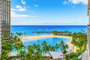 A resort with a large pool, beach, and ocean view. - Ocean & Fireworks Views Condo at the Ilikai Hotel W/full Kitchen & Free Wifi (Honolulu)