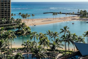A resort with a beach, pool, and palm trees. - Ocean & Fireworks Views Condo at the Ilikai Hotel W/full Kitchen & Free Wifi (Honolulu)