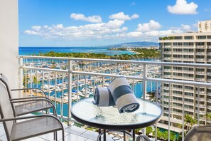A balcony with a view of a marina and distant mountains. - Ocean and Sunset Marina Views at the Ilikai Hotel W/great Building Amenities (Honolulu)