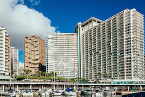 A waterfront hotel with multiple high-rise buildings, a marina with boats, and a clear blue sky. - Tropical City Escape at Ilikai Hotel by the Beach W/great Building Amenities (Honolulu)
