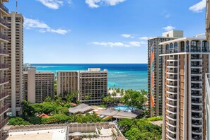 A high-rise hotel with multiple balconies overlooking a beach and ocean. - Ocean & City Views Family-friend Vacation Getaway at Ilikai Hotel by Beach (Honolulu)