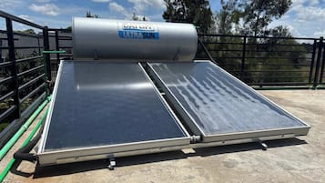 A solar water heater with a cylindrical tank labeled 'Dayliff Ultrasun' mounted on a rooftop.