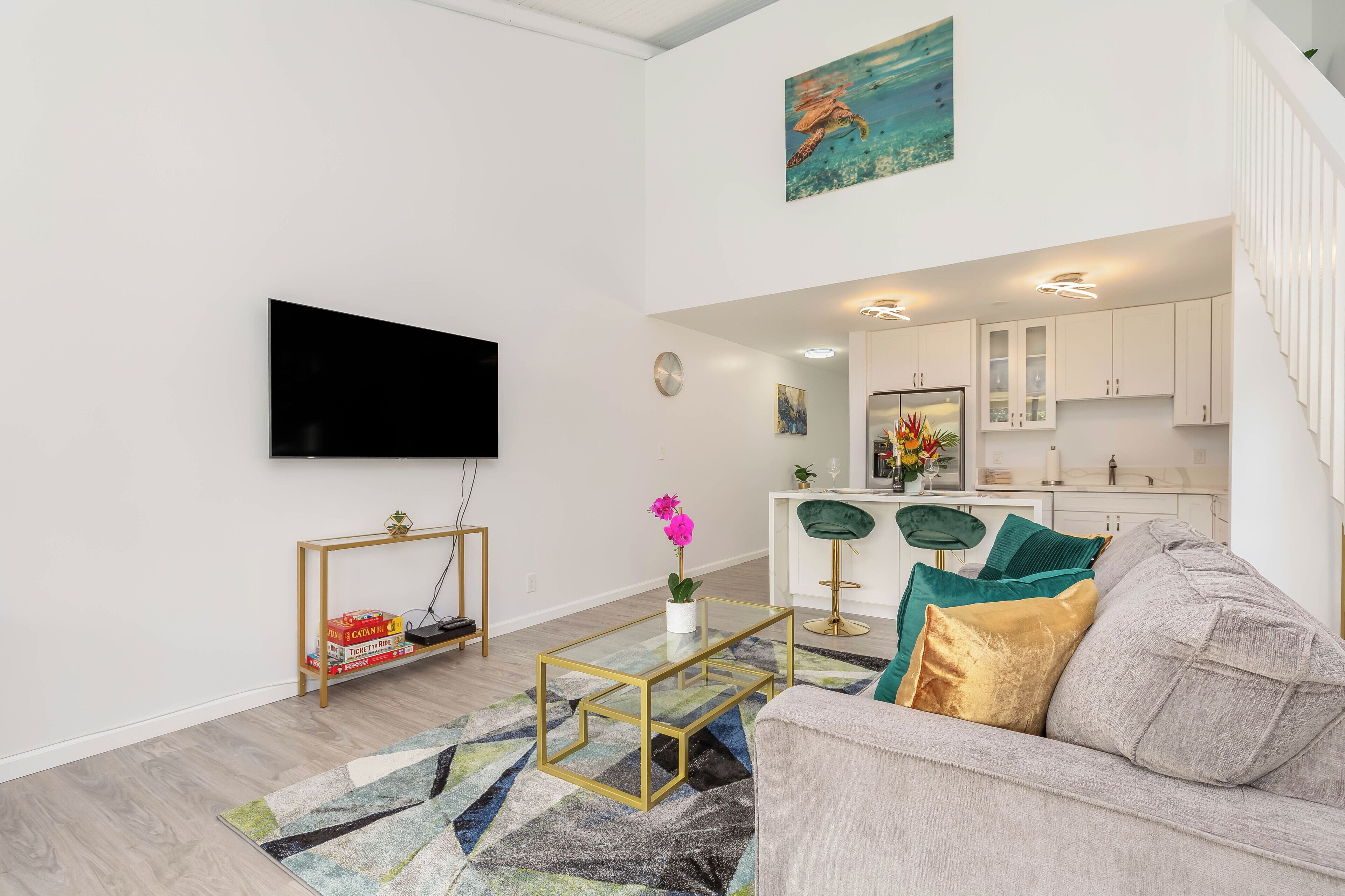 A modern living room with a flat-screen TV, a coffee table, and a sofa.
